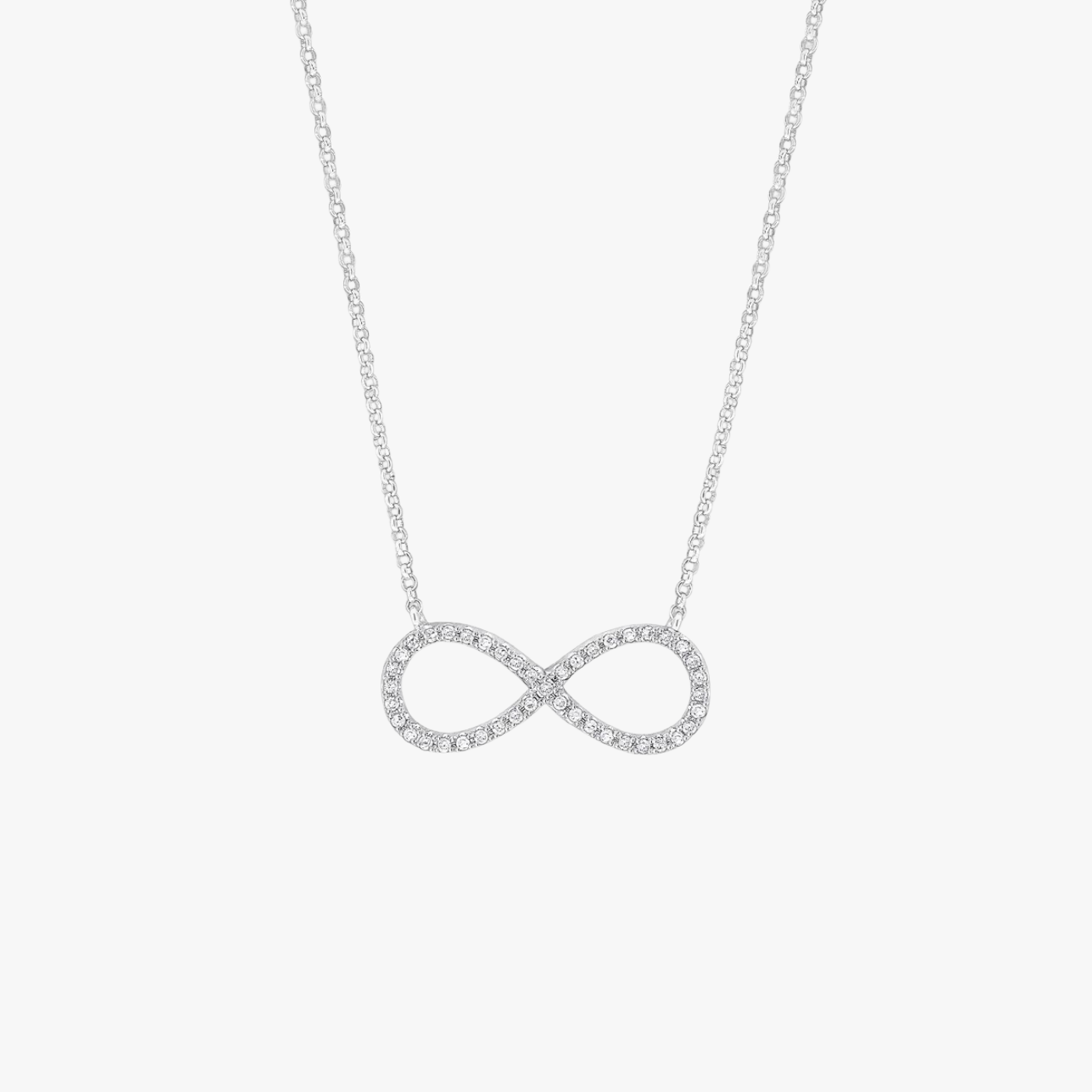 Silver infinity necklace on a light gray background