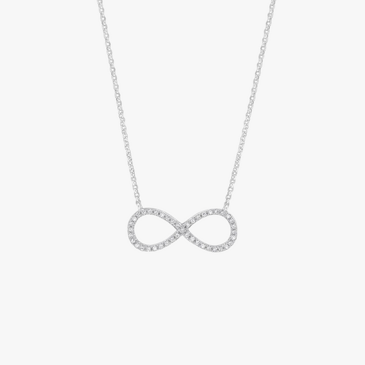 Silver infinity necklace on a light gray background